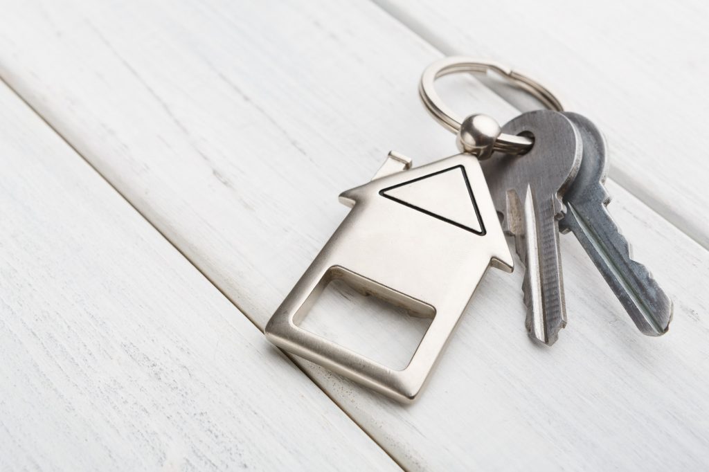 Tips to Make Collecting Rent with Text Messages Easier 1 Bunch of keys with house shaped keychain on white wood