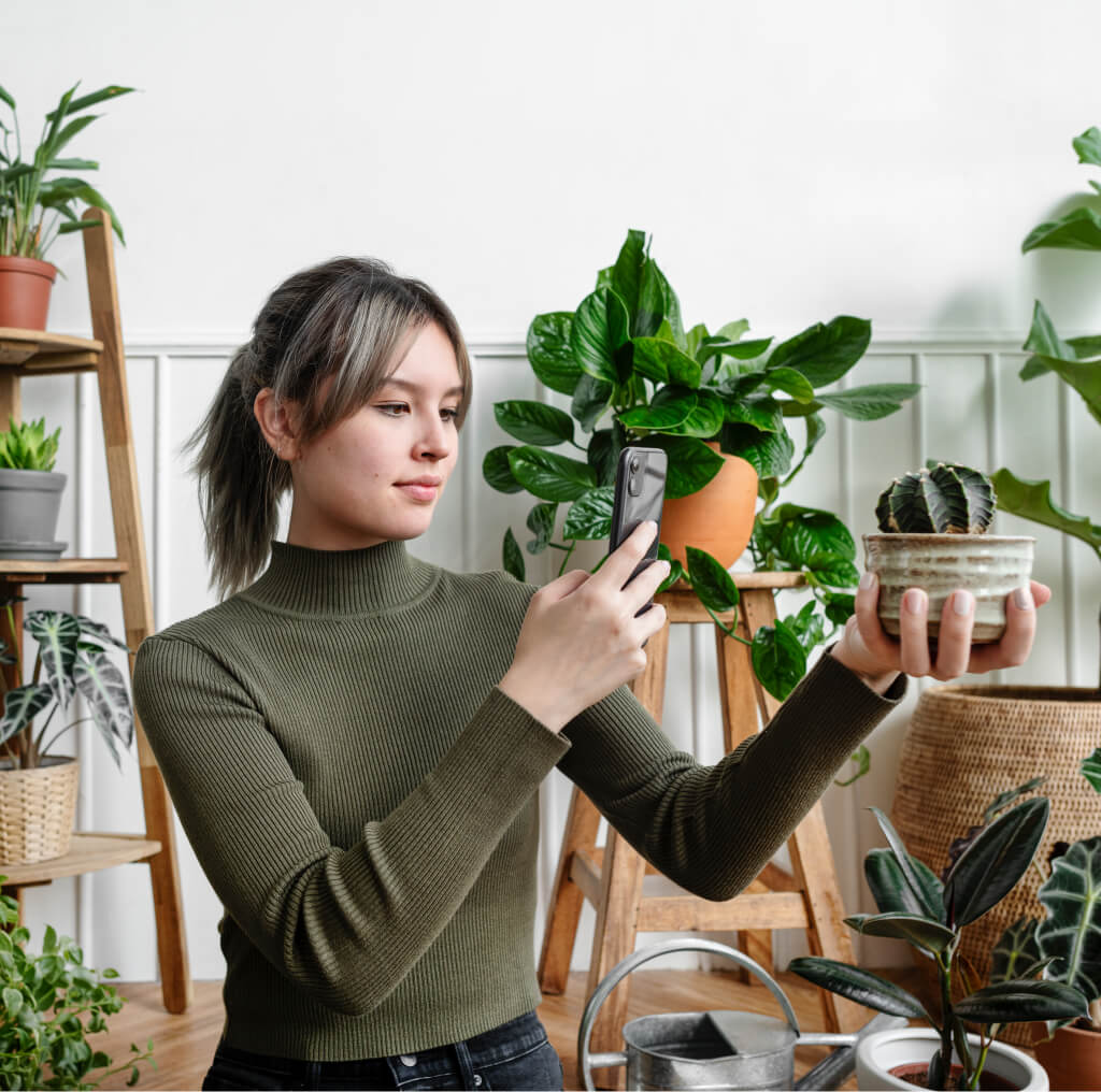 woman taking a snapshot of her plant for social me 2021 10 13 21 44 16 utc 1